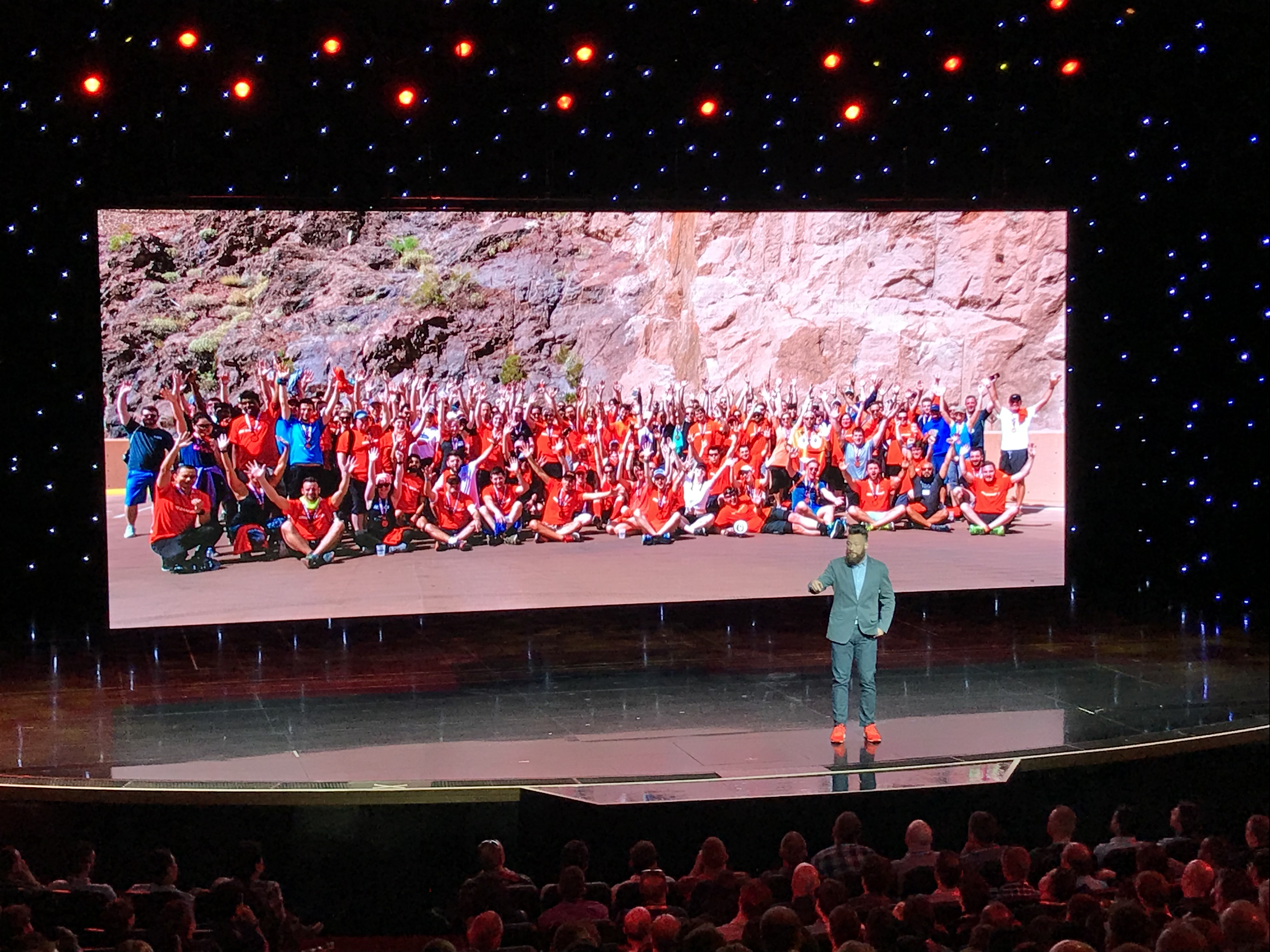 Big Dam Run group photo shown on the Imagine 2018 keynote screen, hundreds of runners in red shirts